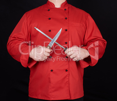 chef in red uniform sharpens a knife