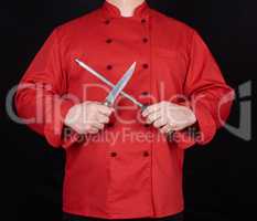 chef in red uniform sharpens a knife