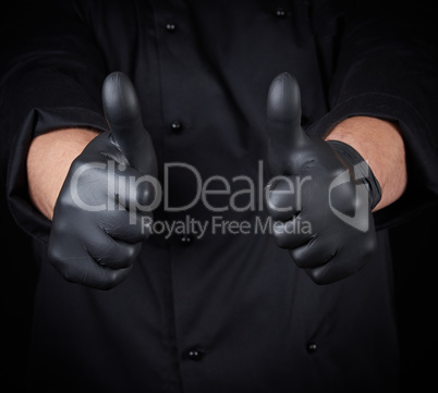 male chef in black uniform shows a gesture of approval