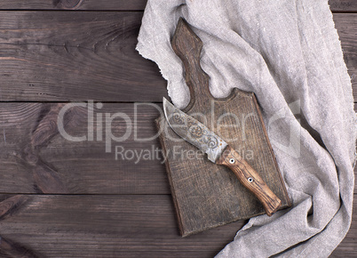 old wooden kitchen board and vintage knife