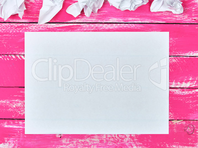 blank white rectangular sheet of paper and crumpled pieces of pa
