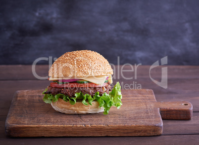cheeseburger with meat patties and white sesame bun