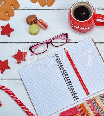 open empty notebook and red wooden pencil