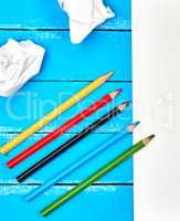multicolored wooden pencils on blue background
