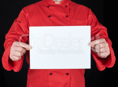 chef in red uniform holding a blank white paper sheet