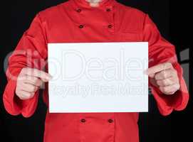 chef in red uniform holding a blank white paper sheet