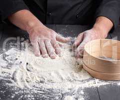 white wheat flour on a black wooden table