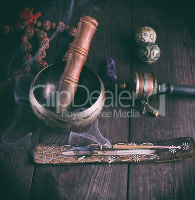 copper singing bowl and a wooden stick