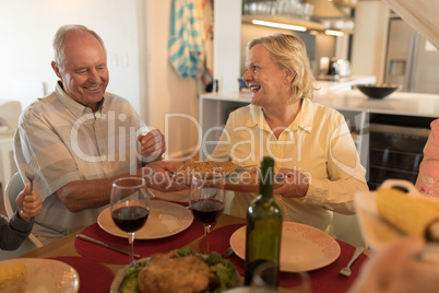 Senior couple interacting with each other on dining table