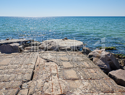view from the stone pier to the sea and clear blue sky
