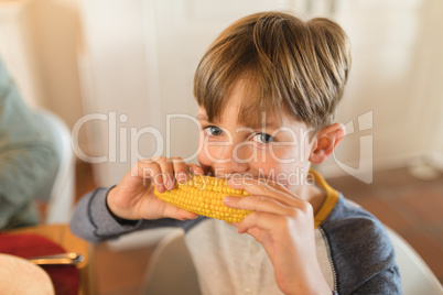 Closeup of a boy eating corn