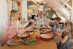 Family having wine on dining table