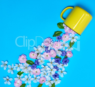 yellow ceramic mug and buds of flowers