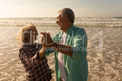 Senior couple dancing together on the beach