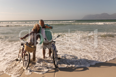 Senior couple taking selfie with mobile phone on the beach