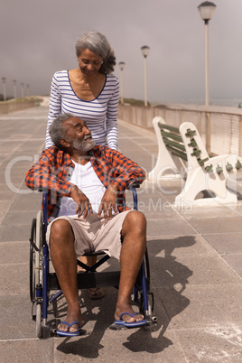 Senior man and senior woman talking with each other on promenade