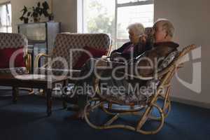 Senior couple relaxing on chair at nursing home