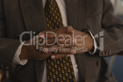 Senior man with hands clasped at nursing home