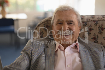 Front view of senior man looking at camera in nursing home