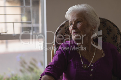 Front view of senior woman looking away at nursing home