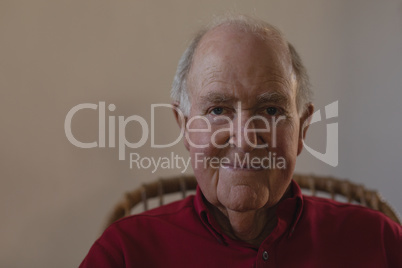 Front view of senior man looking at camera in nursing home