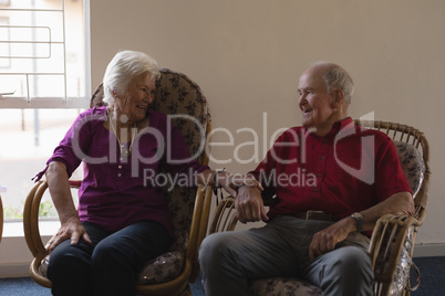 Front view of senior couple interacting with each other at nursing home