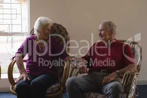 Front view of senior couple interacting with each other at nursing home