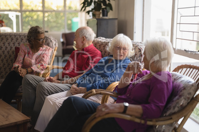Group of senior friends interacting with each other at nursing home