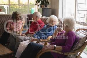 Group of senior friends interacting with each other at nursing home