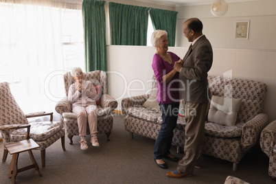 Side view of senior friends dancing together at home