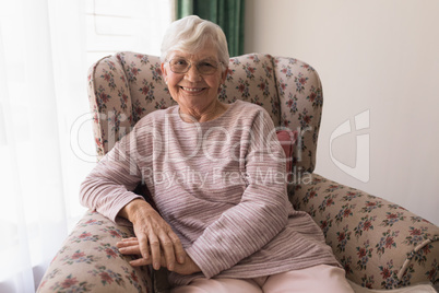 Front view of senior woman looking at camera in home