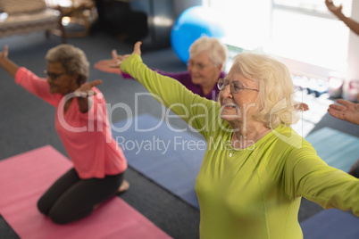 Senior people exercising in fitness studio