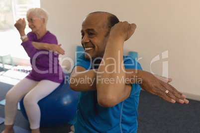 Senior man exercising in fitness studio