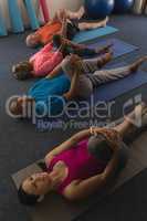 High angle view of young female trainer exercising with senior people