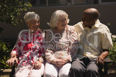 Front view of senior friends interacting with each other in garden