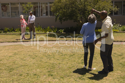 Rear view of senior couple dancing together in garden