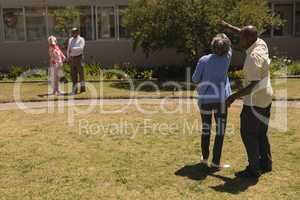 Rear view of senior couple dancing together in garden