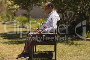 Senior man using laptop in the park