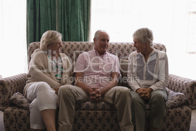 Senior people interacting with each other in living room