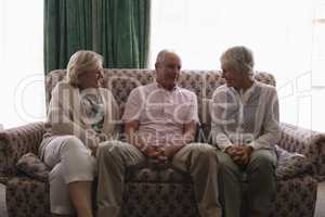 Senior people interacting with each other in living room
