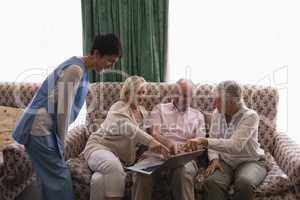 Senior people using laptop in living room