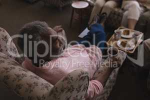 Senior man having black coffee in living room