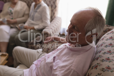 Senior man relaxing in living room at home