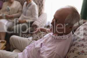 Senior man relaxing in living room at home