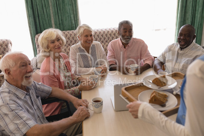 Group of senior people having black coffee in living room