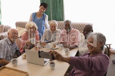 Senior woman taking selfie with mobile phone