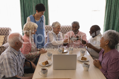 Senior people holding mobile phone at nursing home