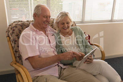 Senior couple using digital tablet at nursing home