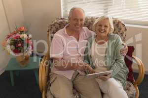 Senior couple using digital tablet at nursing home