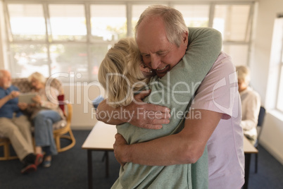 Senior couple embracing each other at nursing home